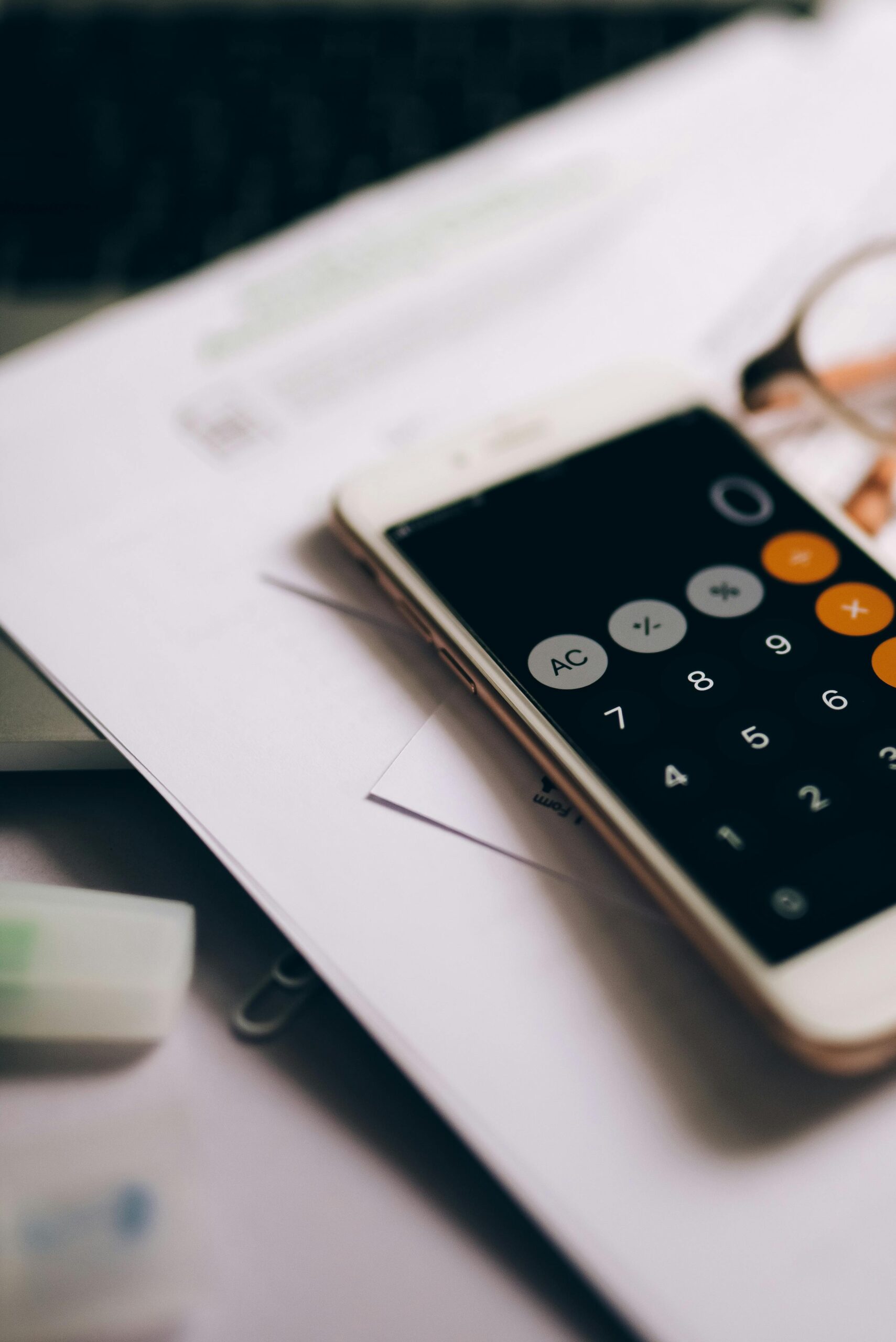 A mobile phone with the calculator screen open. The calculator shows zero.